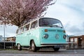 Noordoostpolder Netherlands April 2019, Classic Green and white VW Camper Van parked with couple watching the Sunrise