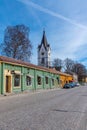 NORA, SWEDEN, APRIL 19, 2019: White church in Nora viewed behind timber houses, Sweden