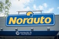 Norauto logo sign in front of the french Automotive Repair and Spare Parts Specialist