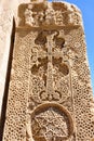 Noravank, Armenia - April, 30 2019: Khachkar - stone stele with carved image of cross and other figures, plots. Armenian