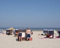 People in bathing suit use beach korbs on the island of norderney in germany Royalty Free Stock Photo