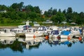 Nordic fishing boats moored at calm lake shore