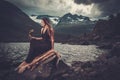 Nordic goddess in ritual garment with hawk near wild mountain lake in Innerdalen valley. Royalty Free Stock Photo