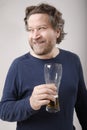 nordic man looking to the side with glass of beer in hand Royalty Free Stock Photo