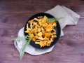 Nordic and russian cuisine : chanterelle mushroom on cast iron flat view
