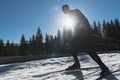 Nordic skiing or Cross-country skiing classic technique practiced by man in a beautiful panoramic trail at morning. Royalty Free Stock Photo