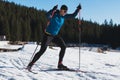 Nordic skiing or Cross-country skiing classic technique practiced by man in a beautiful panoramic trail at morning.