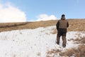 Nordic Walking - adult man climbing to top of a mountain