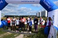 Nordic walking athletes of different ages and genders begin the competition at the start walking in a group