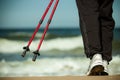 Nordic walking. Female legs hiking on the beach. Royalty Free Stock Photo