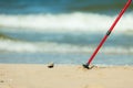 Nordic walking. Red sticks on the sandy beach Royalty Free Stock Photo