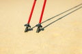 Nordic walking. Red sticks on the sandy beach Royalty Free Stock Photo