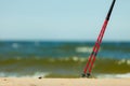 Nordic walking. Red sticks on the sandy beach Royalty Free Stock Photo