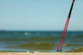 Nordic walking. Red sticks on the sandy beach Royalty Free Stock Photo