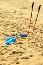 Nordic walking. sticks and violet shoes on a sandy beach Royalty Free Stock Photo