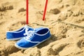 Nordic walking. sticks and violet shoes on a sandy beach Royalty Free Stock Photo