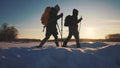 nordic walking in winter. winter hike group of tourists silhouette. teamwork travel. two hikers with sticks walk in the Royalty Free Stock Photo