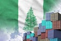 Norfolk island flag and big stack of shipping cargo containers in docks with sky background Royalty Free Stock Photo