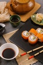 Nori Maki Philadelphia Sushi Rolls Set with Raw Salmon and Cream Cheese on Black Stone Table Background with Place for Text. Royalty Free Stock Photo
