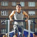 Norilsk, Russia - August, 28, 2016: male runner doing pull ups on the horizontal bar while training at evening outdoors, strong Royalty Free Stock Photo