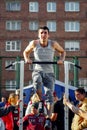 Norilsk, Russia - August, 28, 2016: male runner doing pull ups on the horizontal bar while training at evening outdoors Royalty Free Stock Photo