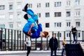 Norilsk, Russia - August, 28, 2016: Young teenager jumps and does somersaults. Parkour on the street. Royalty Free Stock Photo