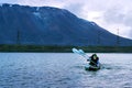 Norilsk, Russia - June 20, 2017: A man and a woman are canoeing on a mountain lake. Royalty Free Stock Photo