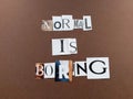 Normal is boring message written on scraps of magazine paper on a brown background