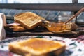 Normal view of a table with toasts, a pot with peach marmalade