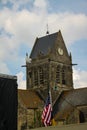 Normandy, France; 4 June 2014: The soldier landed on the steeple of the church of Sainte Mere Eglise