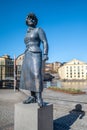 Statue of author Moa Martinson in the historic industrial landscape of Norrkoping