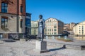 Statue of author Moa Martinson in the historic industrial landscape of Norrkoping