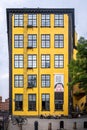 Front facade view of a famous old yellow industrial building. Museum Arbetets Hus with incidental people in Norrkoping Sweden