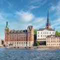 Norstedt Building, or Norstedtshuset, and tower of Riddarholmen Church, Old Town or Gamla stan, Stockholm, Sweden Royalty Free Stock Photo