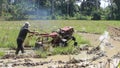 North Aceh, Indonesia, February 5, 2024, farmers use hand tractors to plow rice fields during the day