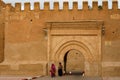 Morocco. Taroudant. Two women in a chador in front of the Bab Sedra gate of the city walls