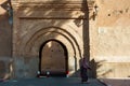 Morocco. Taroudant. A woman in a chador in front of the Bab Sedra gate of the city walls