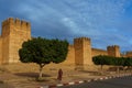 Morocco. Taroudant. A woman walking front of the city walls