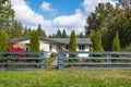 North American Farm country house with fence. Rural Farmhouse on a sunny day in a summer with a garden and green lawn Royalty Free Stock Photo