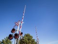 North American level crossing with its typical road sign, saltire shaped, and red and white fences barriers, Royalty Free Stock Photo