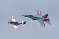 1944 North American P-51D Mustang fighter aircraft D-FPSI leading a Swiss Air Force McDonnell Douglas F/A-18C Hornet in formation Royalty Free Stock Photo