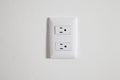 north american power outlet plug in socket on a white wall background Royalty Free Stock Photo