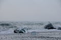 Heavy ocean waves crash onto ice floes from calved glaciers