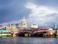 North bank of the river Thames with black friars bridge and St Pauls cathedral surrounded by building works