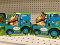 Packages of Lindt Gold Bunny milk chocolate easter candy, riding in a tractor
