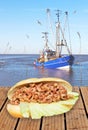 North German Fischbroetchen with crab cutter in the background