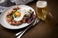 North German Hamburg Labskaus is a delicacy with corned beef, potatoes, beetroot, pickled gherkins, fried egg, herring and beer on