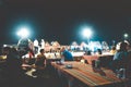 North Goa, India - January 2, 2019: Customers dining at a famous coastal cafes in the late night party. It outdoor restaurant cafe