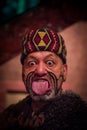 NORTH ISLAND, NEW ZEALAND- MAY 17, 2017: Close up of a Maori man sticking out tongue with traditionally tatooed face in Royalty Free Stock Photo