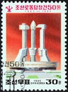 NORTH KOREA - CIRCA 1995: A stamp printed in North Korea shows statue of three workers holding party symbols, circa 1995.